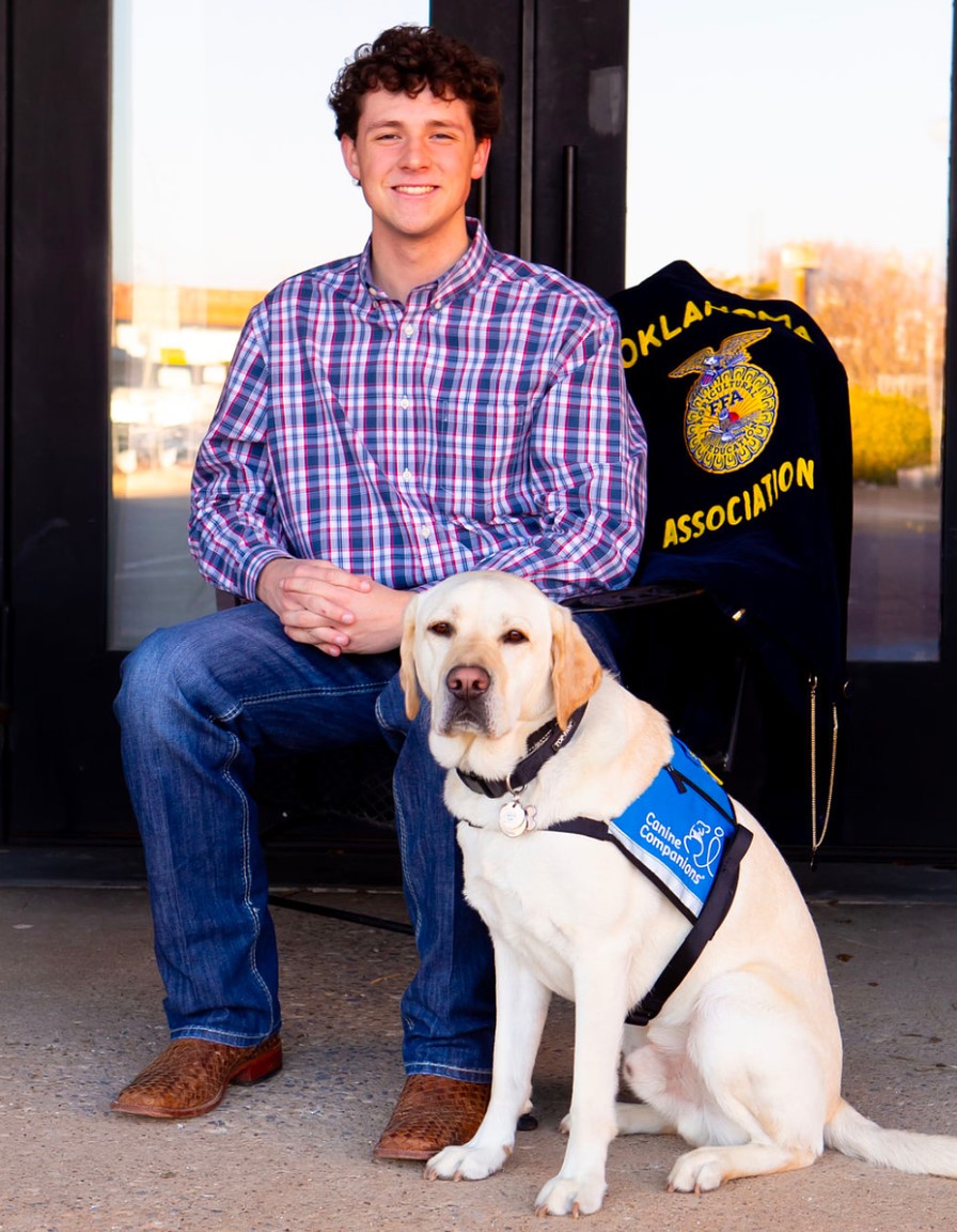young man with yellow lab service dog